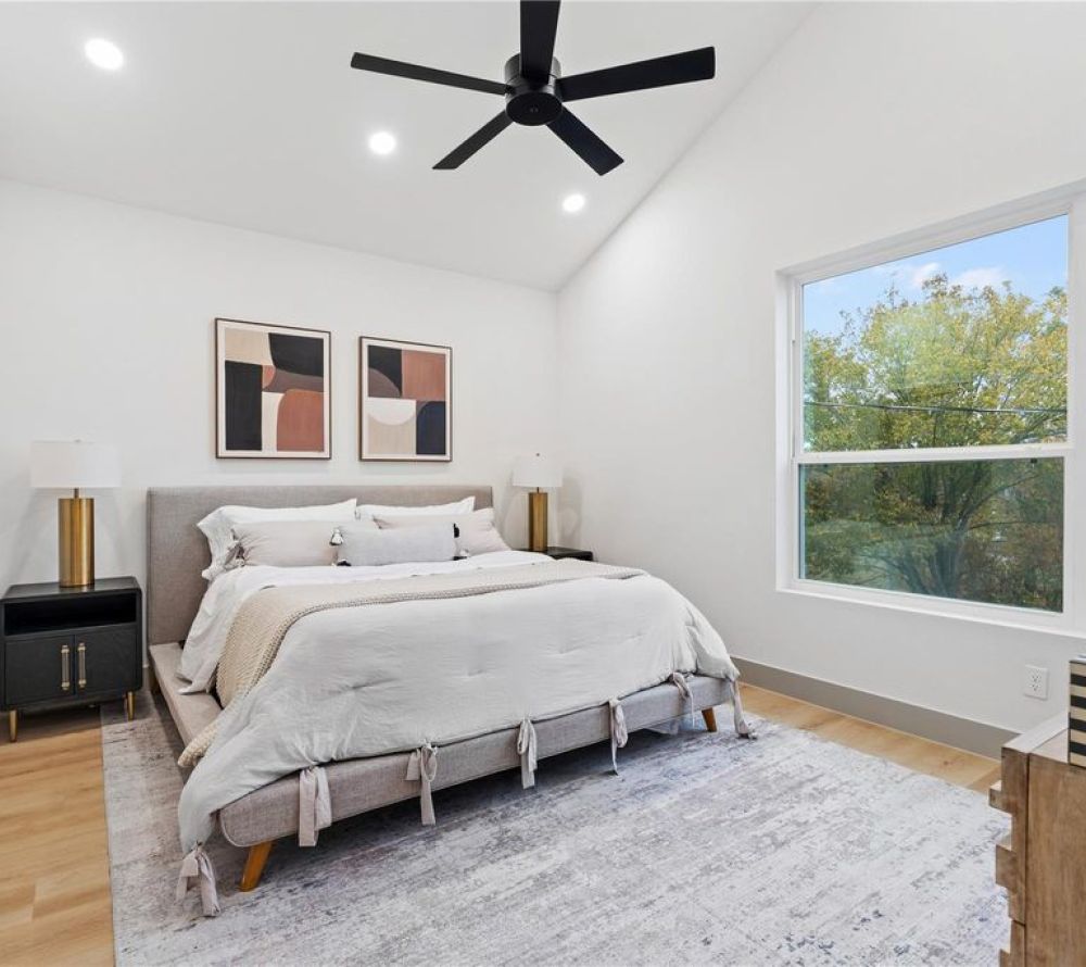 An expansive open-concept layout defined by ceiling height, clean sightlines, and abundant natural light—where living, dining, and kitchen spaces connect seamlessly through intentional design and proportion.